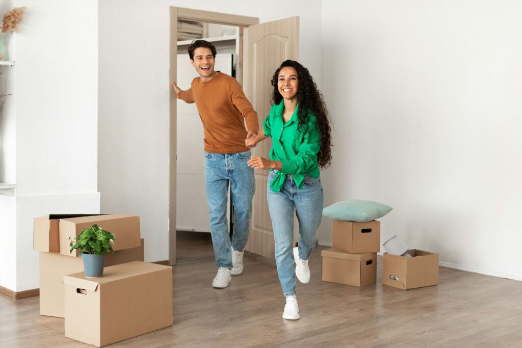 Happy excited couple running in new house